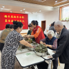 阳泉市城区金三角社区开展 “糯米裹粽承古韵 墨香盈袖话清风” 活动
